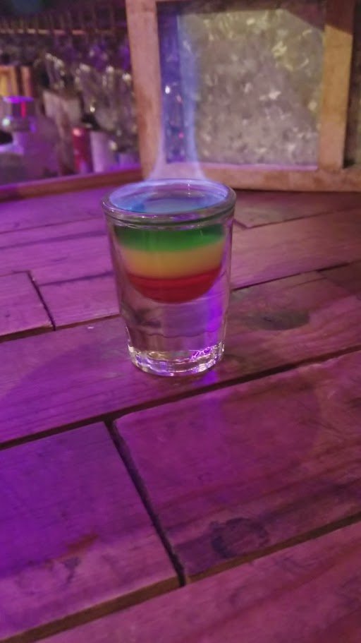 Tropical cocktails beside hearty Jamaican dishes.
