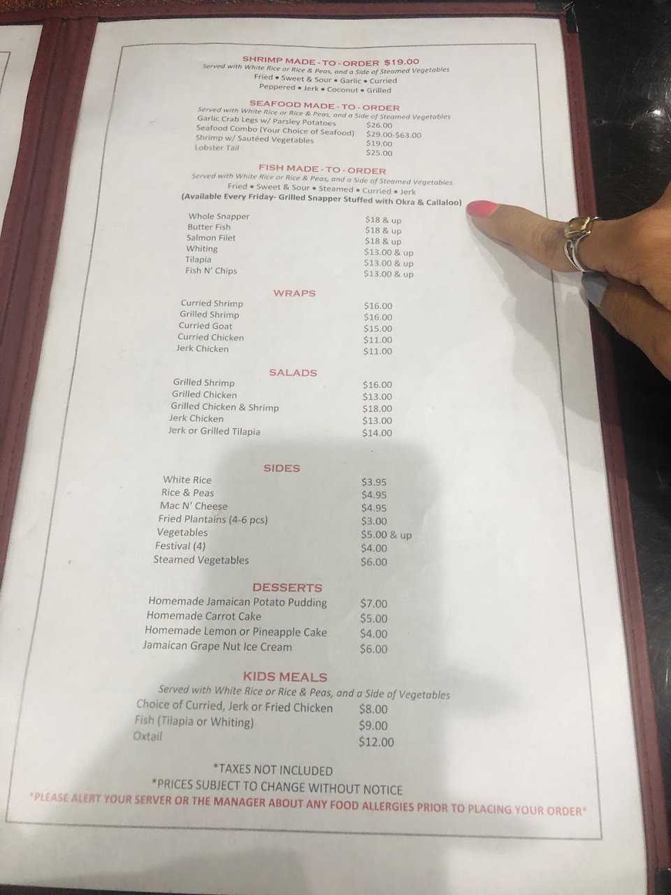 Menu page with Caribbean dishes and sides.